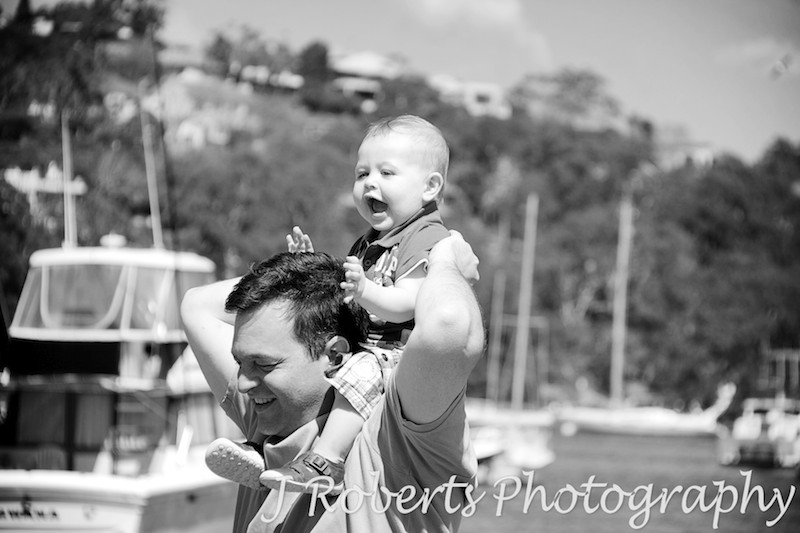 Little boy on his dad's shoulders - family portrait photography sydney